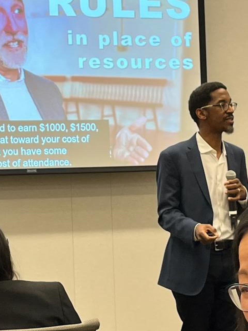 Akil Bello presenting Rules in Place of Resources talk