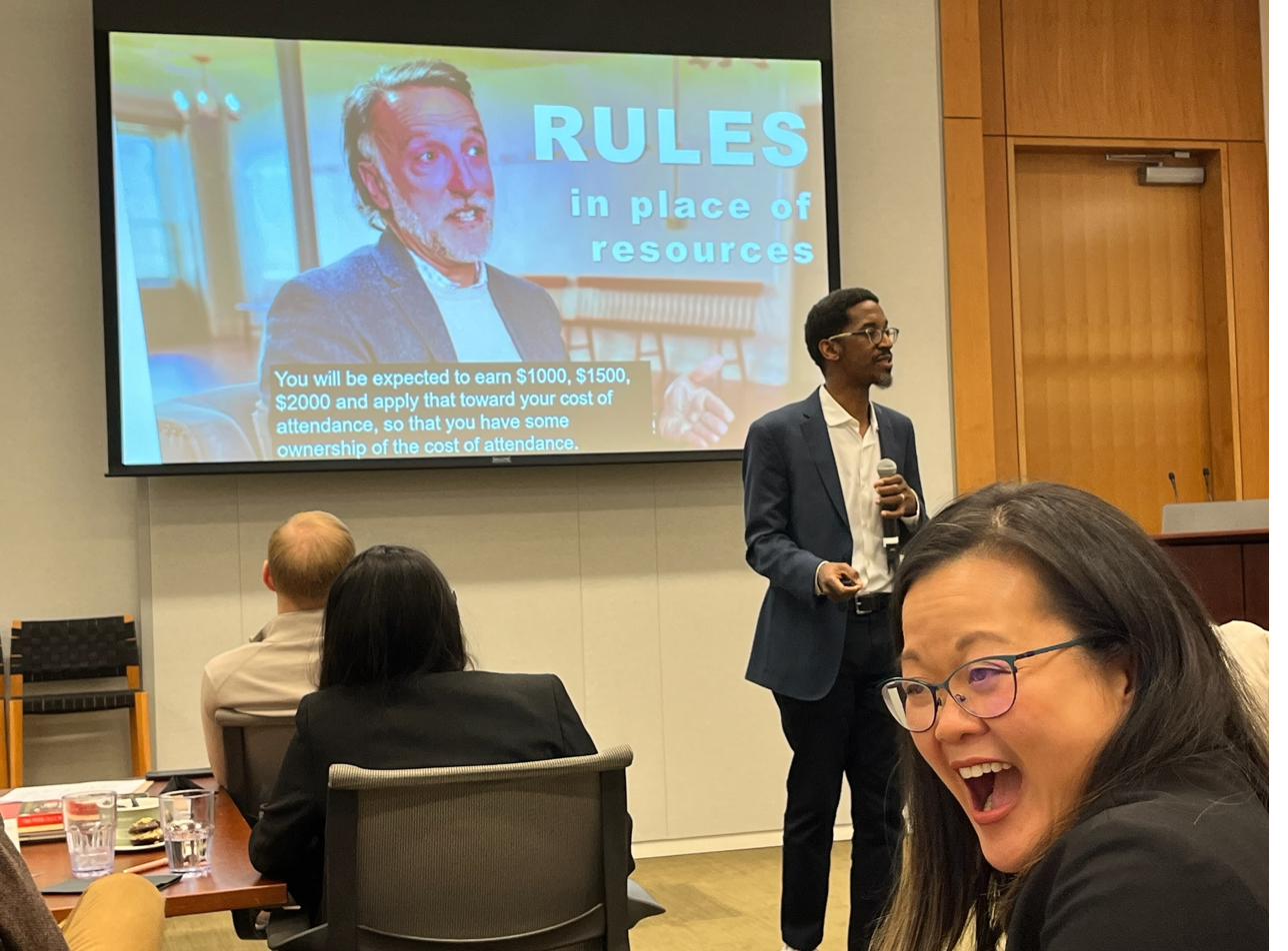 Akil Bello presenting — audience reaction says it all
