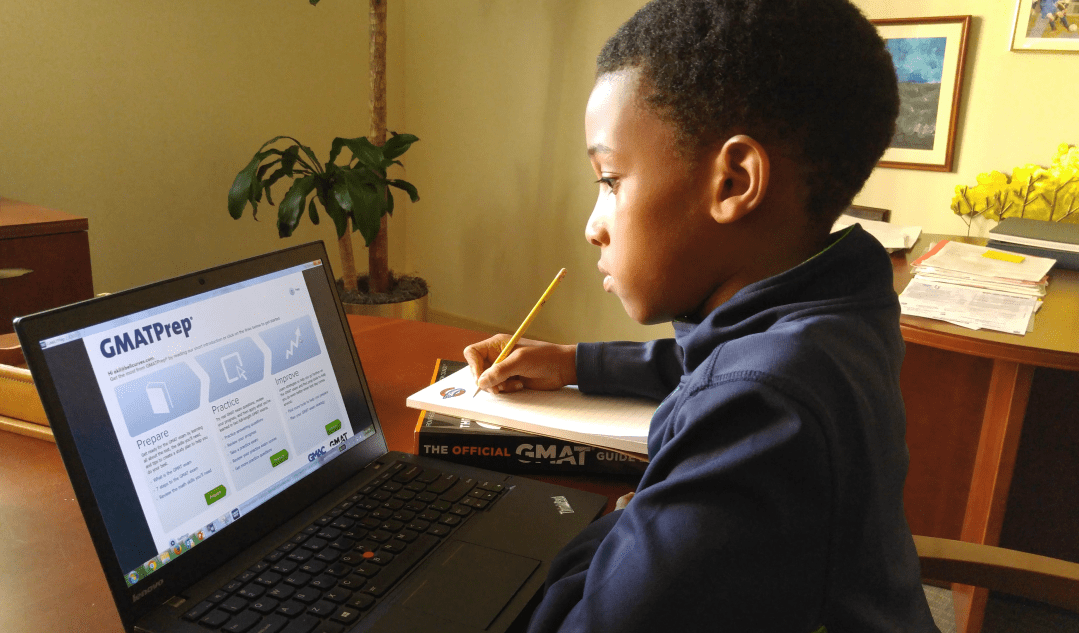 A child studying for the GMAT to get into business school.